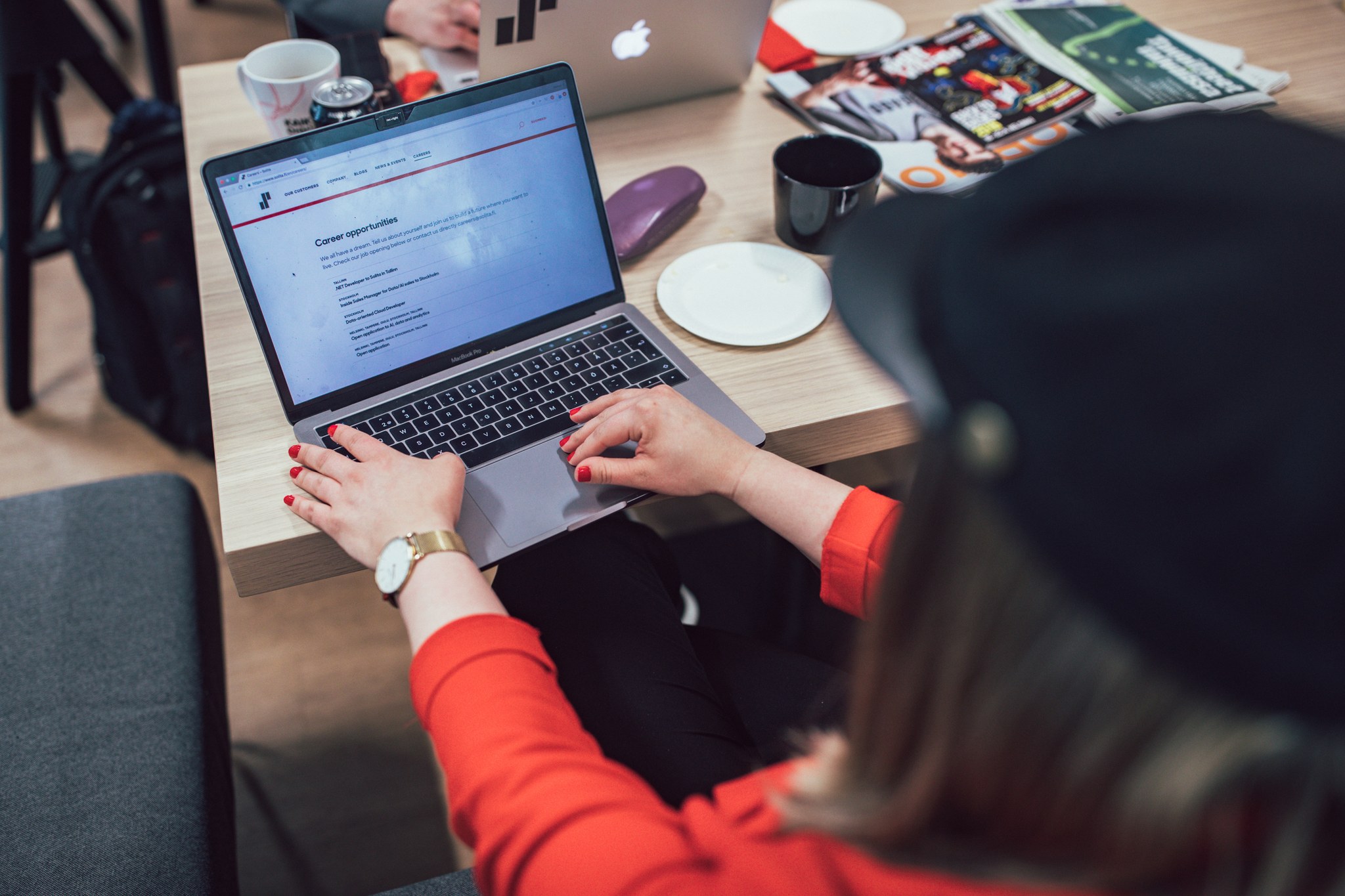 A person sitting in front of a laptop